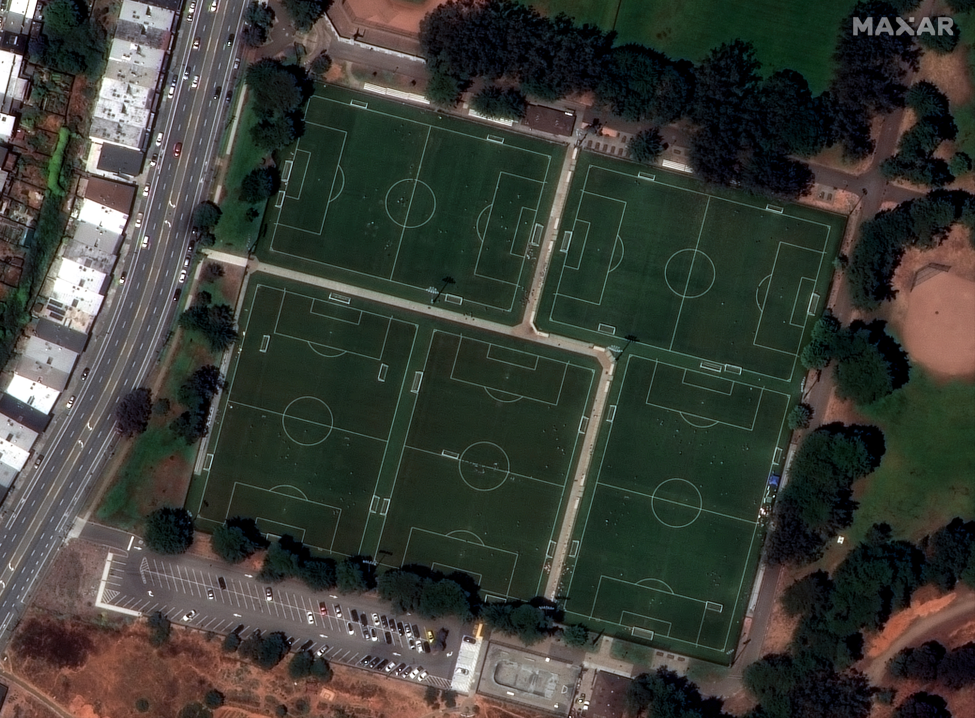 This WorldView Legion image shows people playing on soccer fields, with cleanly defined white boundary lines and stadium lights.