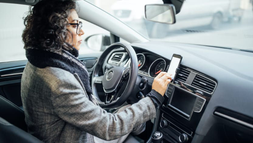 Driver looking at mobile map in a vehicle